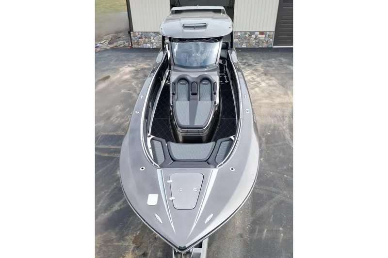 Slide: The Image of 2018 MTI V42 boat with sleek design and modern seating, parked outdoors. - 8