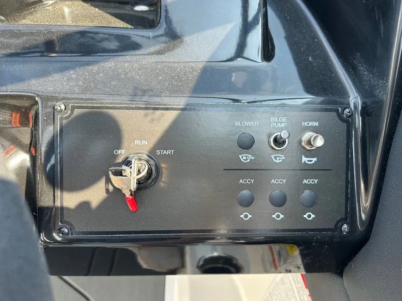 Slide: The Image of Dashboard of 2026 Bayliner V20i with switches and ignition key. - 21