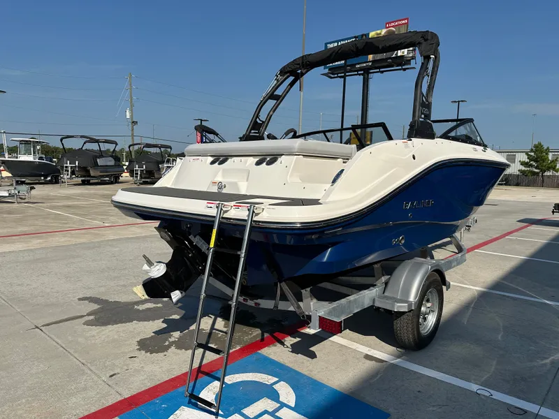 Slide: The Image of 2026 Bayliner V20i boat parked on trailer outdoors. - 7