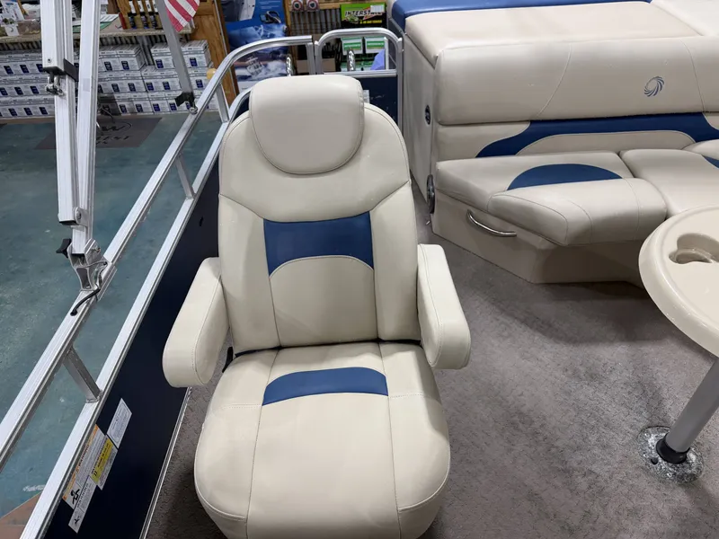 Slide: The Image of Interior of a 2014 Lowe SS 210 boat with beige and blue seating. - 11