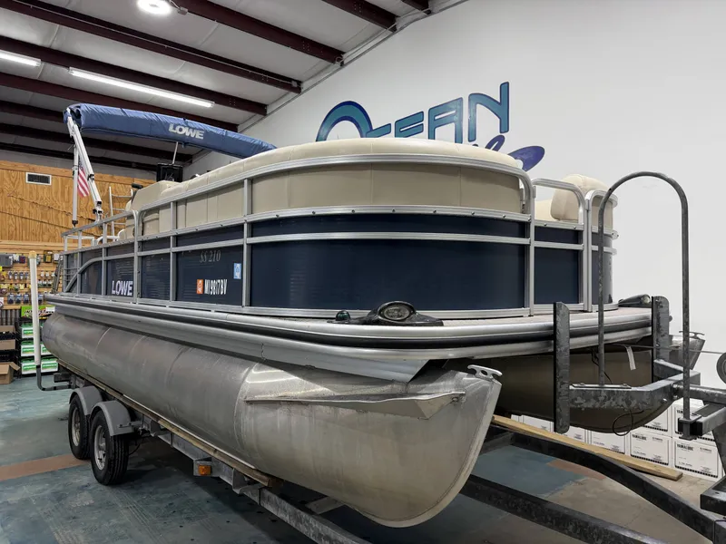 Slide: The Image of 2014 Lowe SS 210 pontoon boat in a storage facility. - 3