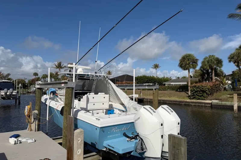 The Image of 2022 Bluewater 2850 CC boat on trailer, parked on grass under clear blue sky. - 0