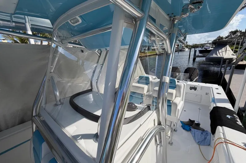 Slide: The Image of 2022 Bluewater 2850 CC boat detail with stainless steel fittings and blue canopy. - 12