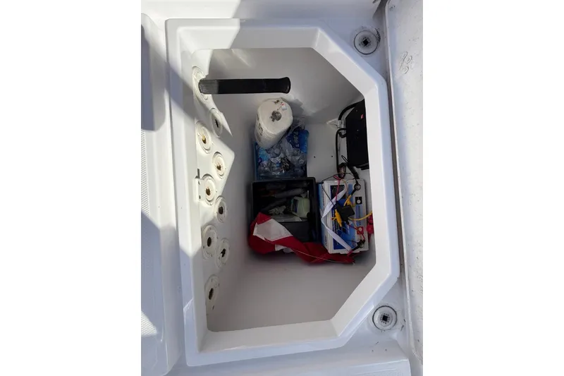 Slide: The Image of Storage compartment of 2022 Bluewater 2850 CC boat with equipment inside. - 14