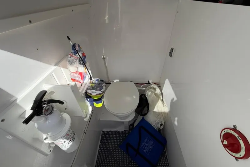 Slide: The Image of Storage compartment of 2022 Bluewater 2850 CC boat with various items inside. - 15