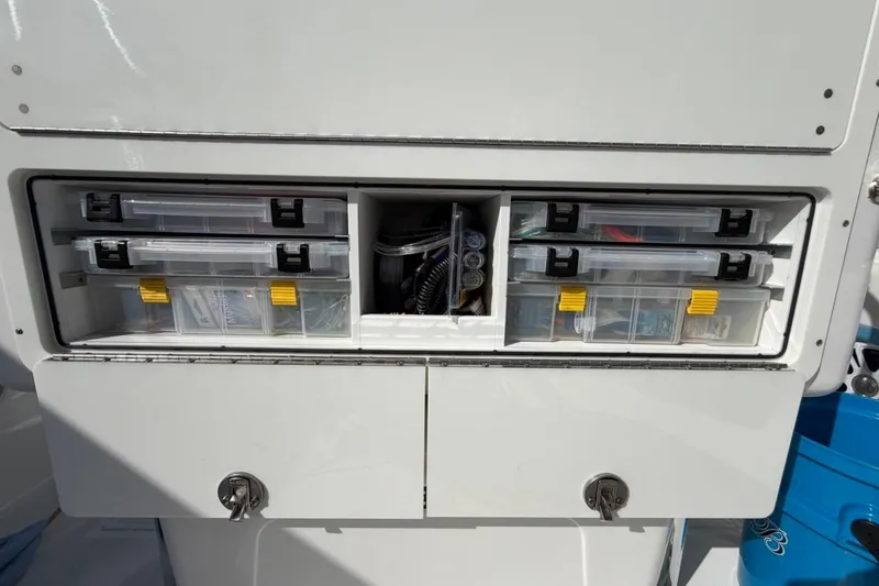 Slide: The Image of 2022 Bluewater 2850 CC boat storage compartment with fishing gear and accessories. - 18