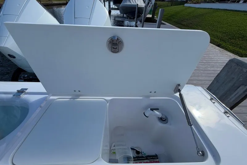 Slide: The Image of Storage compartments on a 2022 Bluewater 2850 CC boat, featuring organized tackle boxes. - 19