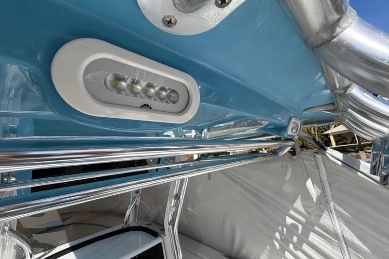 Slide: The Image of 2022 Bluewater 2850 CC boat interior with storage, Yeti cooler, and blue bucket. - 23