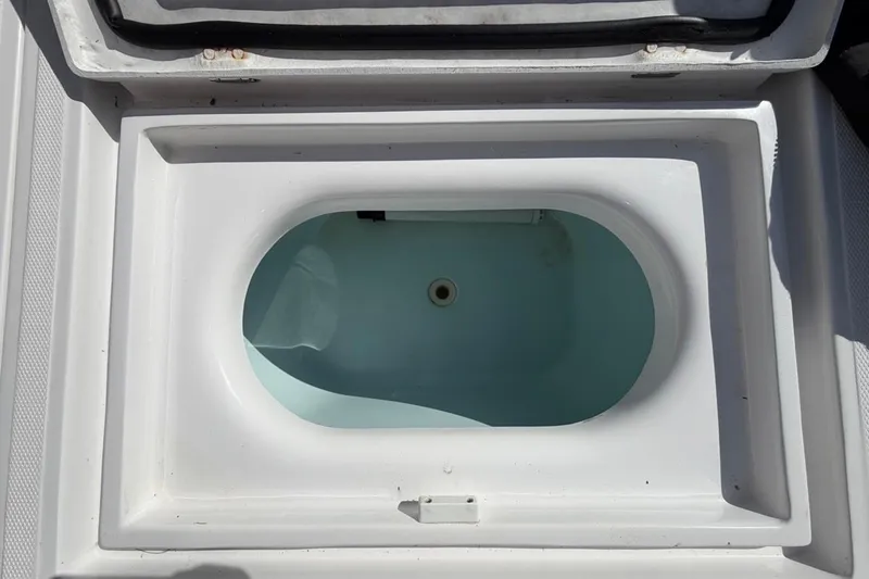 Slide: The Image of Storage compartment on a 2022 Bluewater 2850 CC boat with rope and anchor. - 25