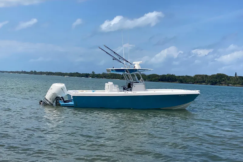 Slide: The Image of 2022 Bluewater 2850 CC boat on calm water under a clear blue sky. - 30