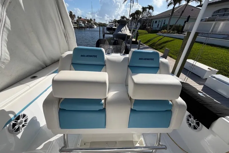 Slide: The Image of 2022 Bluewater 2850 CC boat with dual blue and white cushioned seats. - 4