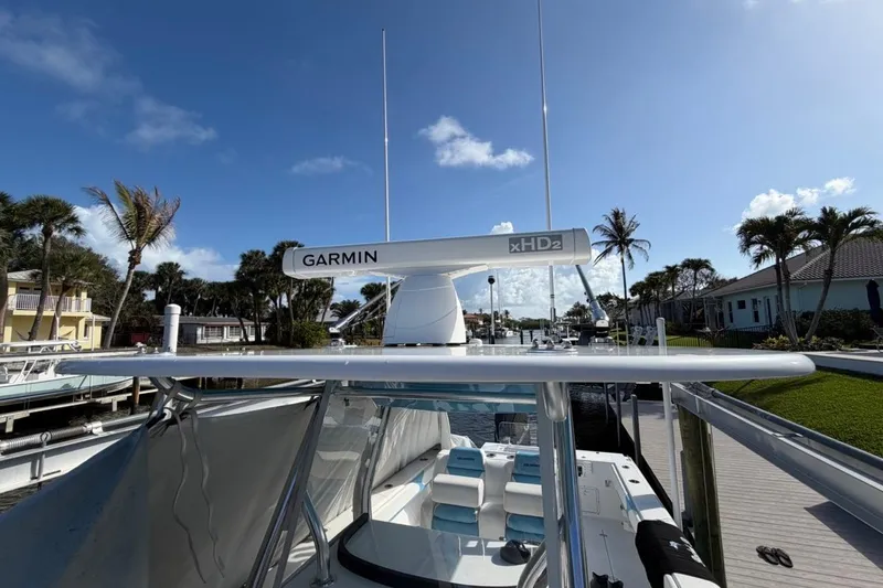 Slide: The Image of 2022 Bluewater 2850 CC boat interior with blue and white seating and storage compartment. - 9