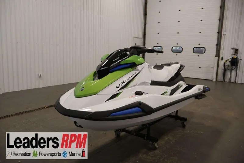 The Image of 2026 Yamaha WaveRunner VX Deluxe in showroom, green and white design, Leaders RPM logo visible. - 1
