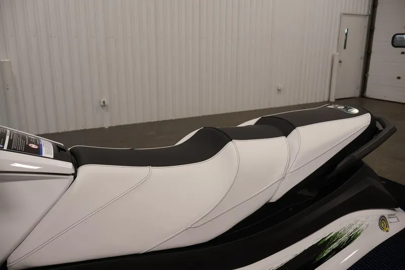 Slide: The Image of 2026 Yamaha WaveRunner VX Deluxe, sleek white and black seat design in a showroom. - 15