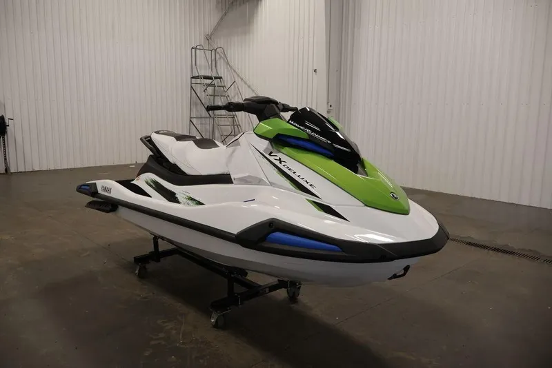 Slide: The Image of 2026 Yamaha WaveRunner VX Deluxe in a showroom, featuring a sleek green and white design. - 2