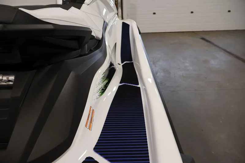 Slide: The Image of 2026 Yamaha WaveRunner VX Deluxe, sleek design, close-up view in a garage setting. - 20