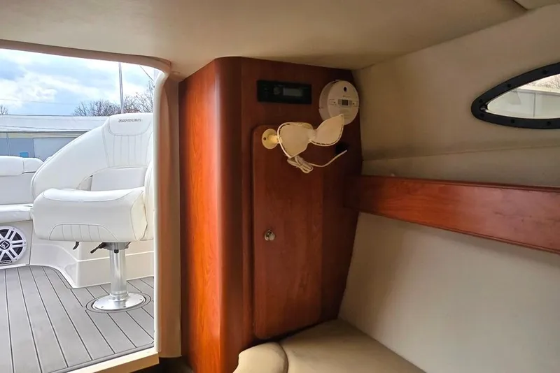 Slide: The Image of Interior of 2006 Rinker 246 Captiva Cuddy boat with seating and wood accents. - 11