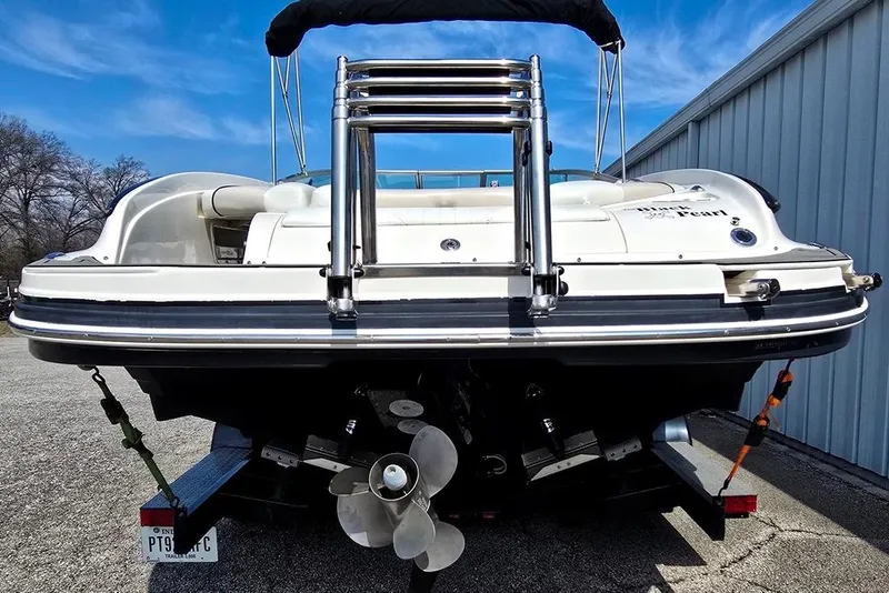 Slide: The Image of 2006 Rinker 246 Captiva Cuddy boat on trailer, rear view with propeller visible. - 18