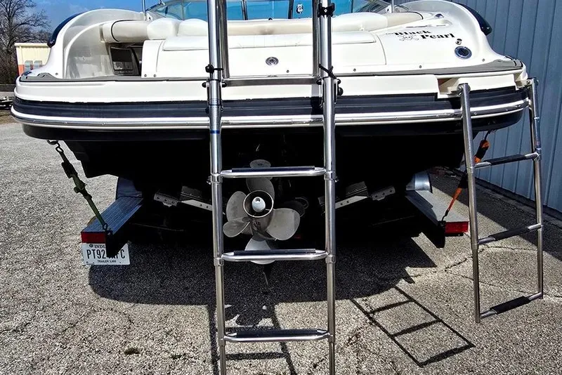 Slide: The Image of 2006 Rinker 246 Captiva Cuddy boat rear view with dual ladders and propeller. - 19