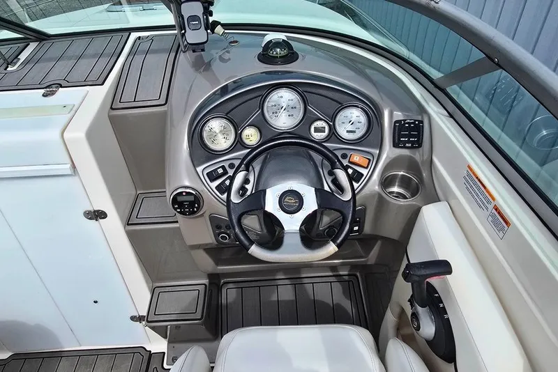 Slide: The Image of 2006 Rinker 246 Captiva Cuddy boat dashboard with steering wheel and instrument panel. - 25