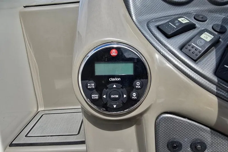 Slide: The Image of Control panel of a 2006 Rinker 246 Captiva Cuddy boat with Clarion audio system. - 27