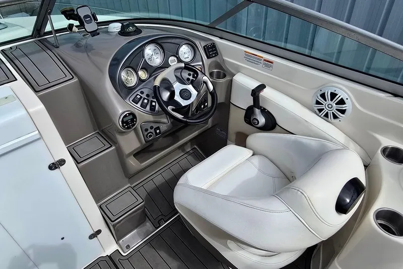Slide: The Image of 2006 Rinker 246 Captiva Cuddy boat cockpit with steering wheel and controls. - 3
