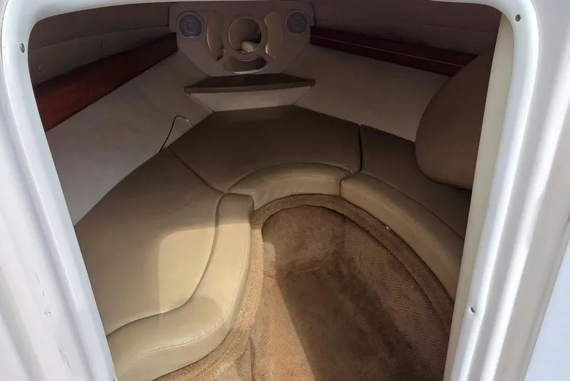 Slide: The Image of 2006 Rinker 246 Captiva Cuddy cabin interior with beige seating and carpet. - 8