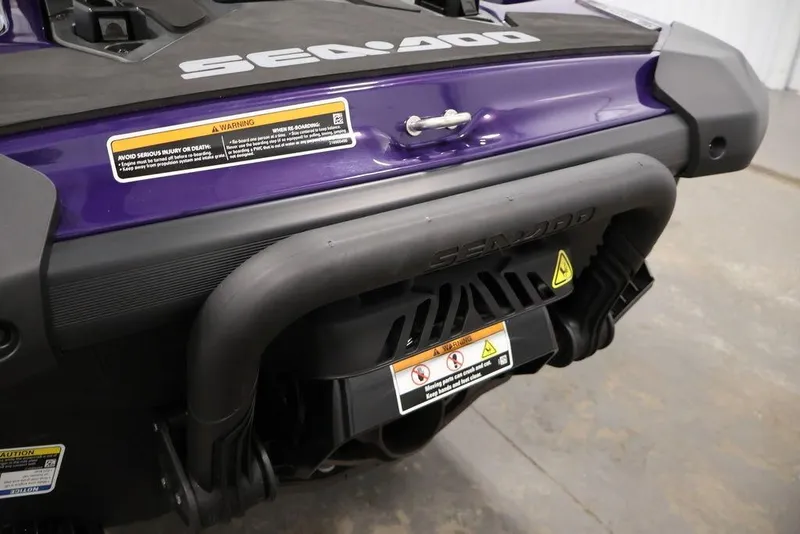 Slide: The Image of 2025 Sea-Doo GTI SE 170 rear view, showcasing purple body and safety warnings. - 17