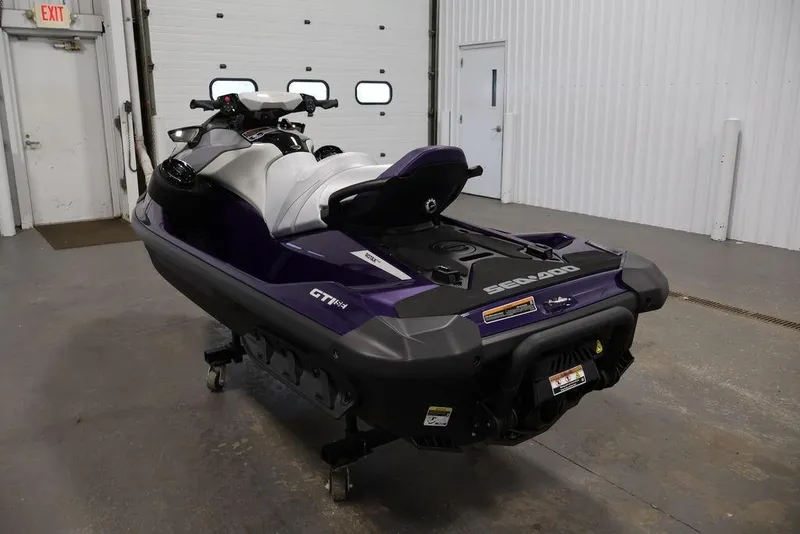 Slide: The Image of 2025 Sea-Doo GTI SE 170 jet ski in a garage, rear view. - 6