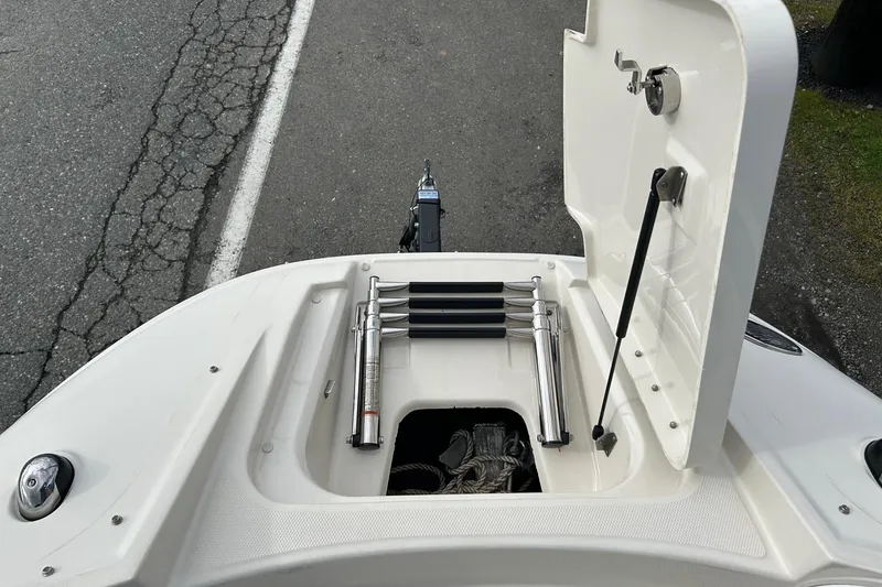 Slide: The Image of 2010 Sea Ray 260 Sundeck boat with open storage compartment and ladder. - 13