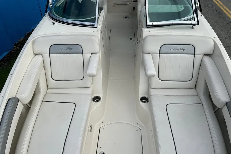 Slide: The Image of 2010 Sea Ray 260 Sundeck interior with white seating and cup holders. - 15