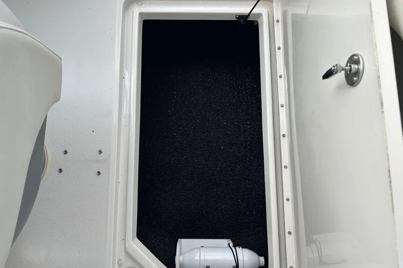 Slide: The Image of Storage compartment on a 2010 Sea Ray 260 Sundeck boat, featuring a white interior. - 18