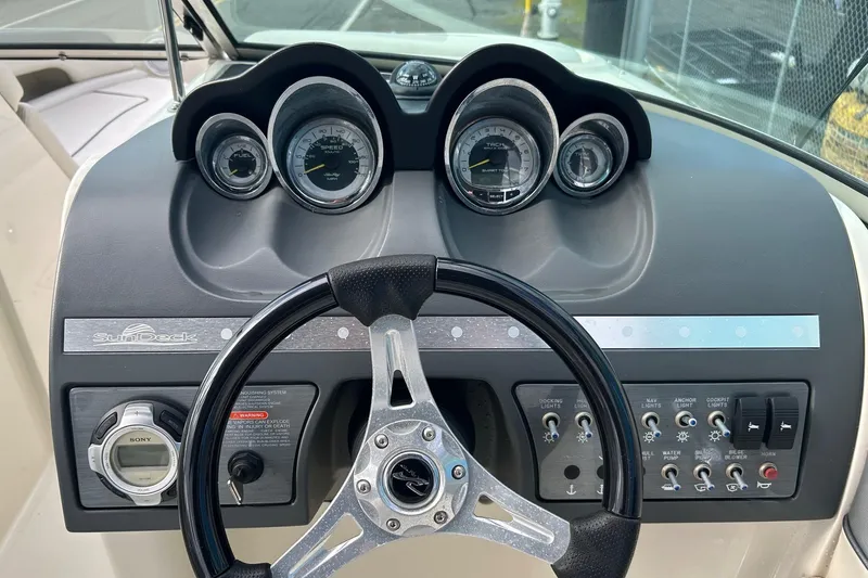 Slide: The Image of Steering console of 2010 Sea Ray 260 Sundeck with gauges and controls. - 2