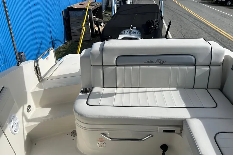 Slide: The Image of 2010 Sea Ray 260 Sundeck boat interior with white seating and cup holder. - 23