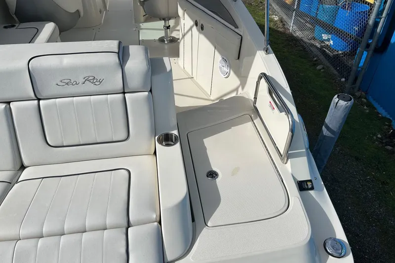 Slide: The Image of 2010 Sea Ray 260 Sundeck interior with white seating and stainless steel accents. - 24
