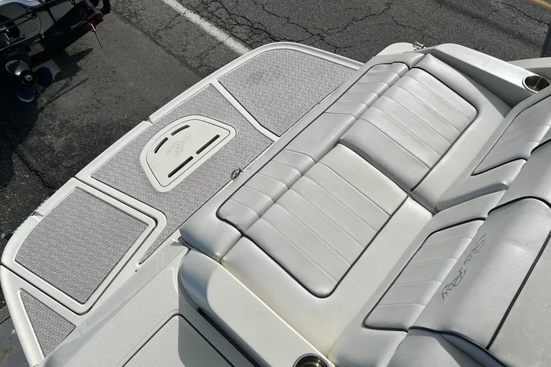 Slide: The Image of 2010 Sea Ray 260 Sundeck boat with white cushioned seating and swim platform. - 26