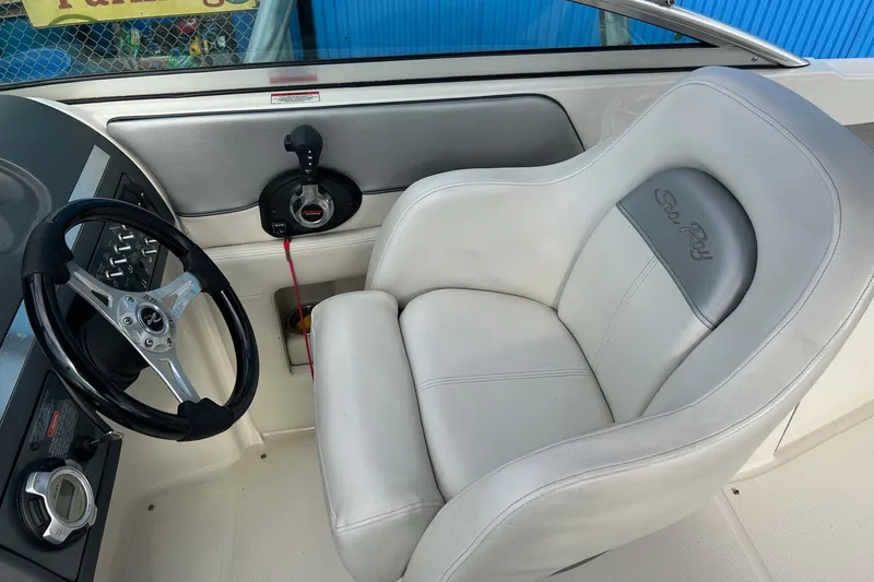Slide: The Image of 2010 Sea Ray 260 Sundeck helm with steering wheel and captain's chair. - 3