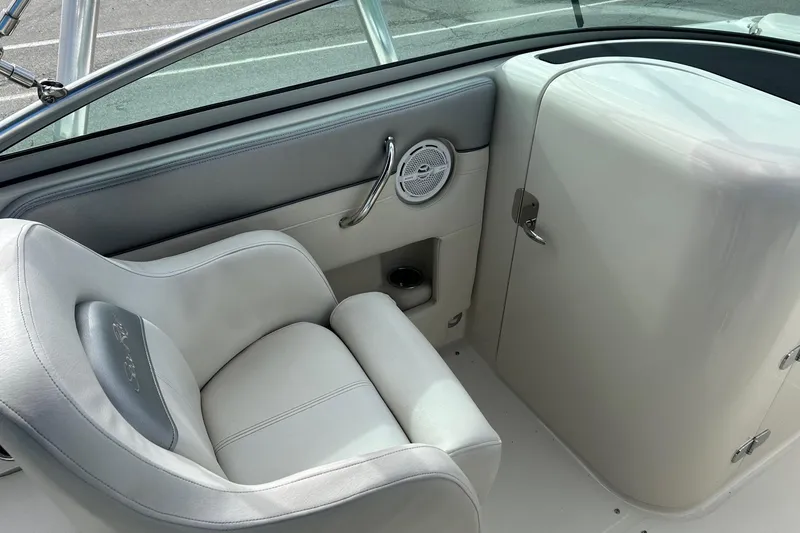 Slide: The Image of 2010 Sea Ray 260 Sundeck interior with white seating and speaker detail. - 5