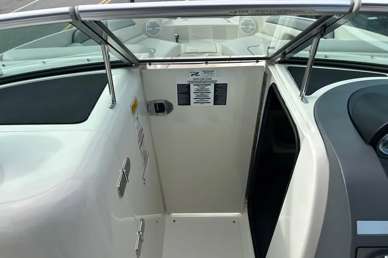 Slide: The Image of 2010 Sea Ray 260 Sundeck interior with open cabin door and seating area. - 8