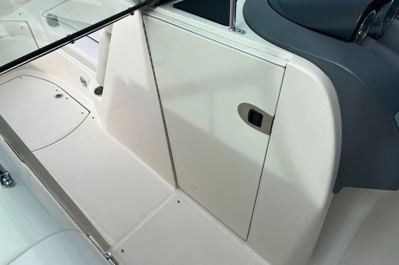 Slide: The Image of 2010 Sea Ray 260 Sundeck interior with white and gray detailing. - 9