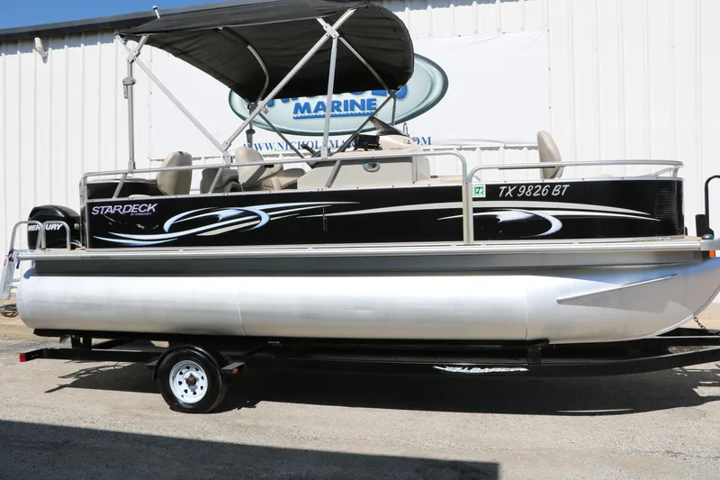The Image of 2012 Starcraft Stardeck 206 4-PT pontoon boat with canopy, parked on trailer. - 1