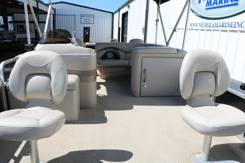 Slide: The Image of 2012 Starcraft Stardeck 206 4-PT boat interior with beige seating and helm. - 16