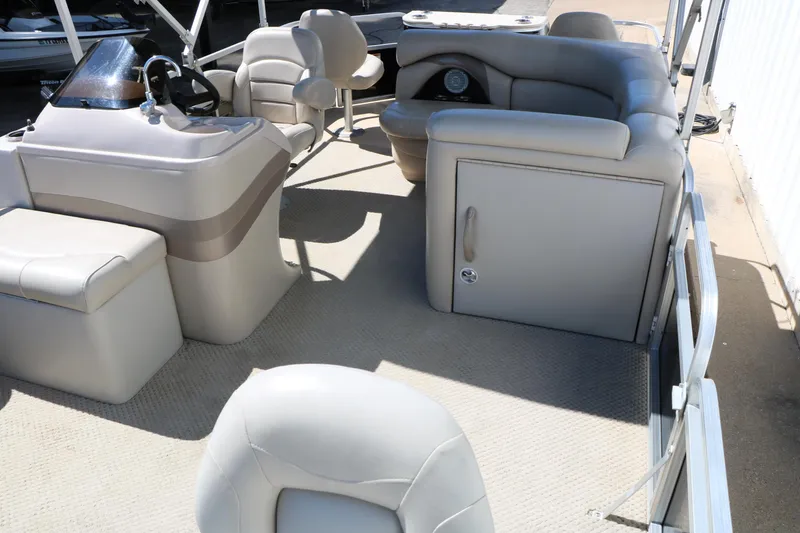 Slide: The Image of 2012 Starcraft Stardeck 206 4-PT boat interior with beige seating and helm. - 18