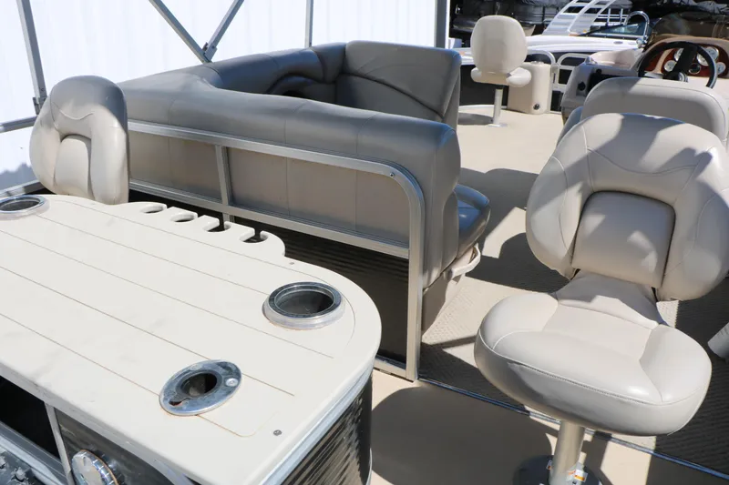 Slide: The Image of 2012 Starcraft Stardeck 206 4-PT boat interior with beige seating and table. - 22