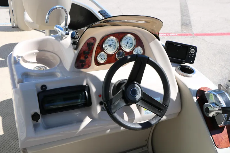 Slide: The Image of 2012 Starcraft Stardeck 206 4-PT boat dashboard with steering wheel and gauges. - 26