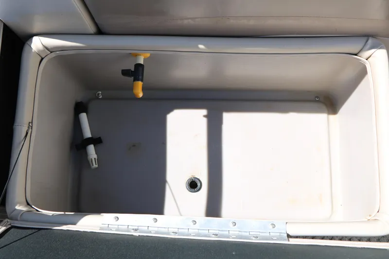 Slide: The Image of 2012 Starcraft Stardeck 206 4-PT boat storage compartment with drain and fittings. - 31