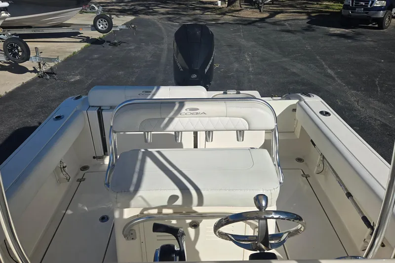 Slide: The Image of 2022 Cobia 237 Center Console boat interior with steering wheel and seating. - 13