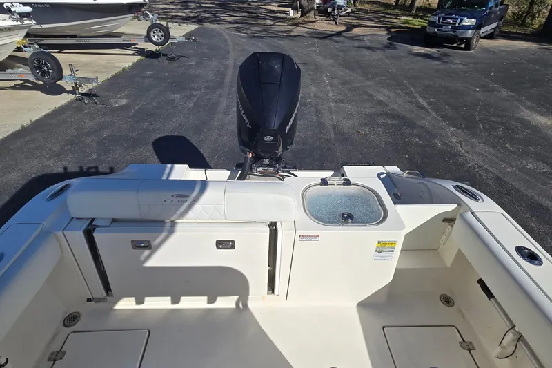 Slide: The Image of 2022 Cobia 237 Center Console boat interior with Mercury engine and seating. - 14