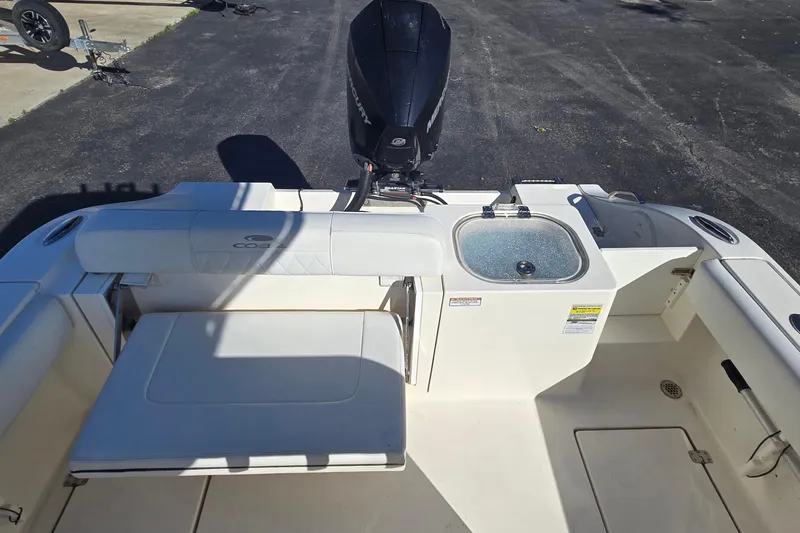 Slide: The Image of 2022 Cobia 237 Center Console boat interior with seating and motor. - 15