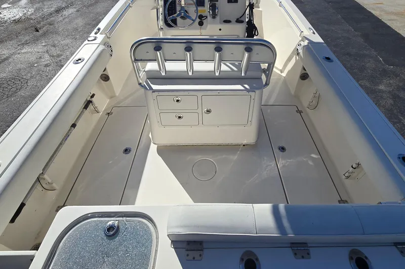 Slide: The Image of 2022 Cobia 237 Center Console boat interior with storage compartments and seating. - 16